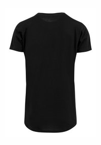 Svart bomull t-skjorte med korte ermer og rund hals. Har en rett passform og buet kant nederst. Enkelt og tidløst design.