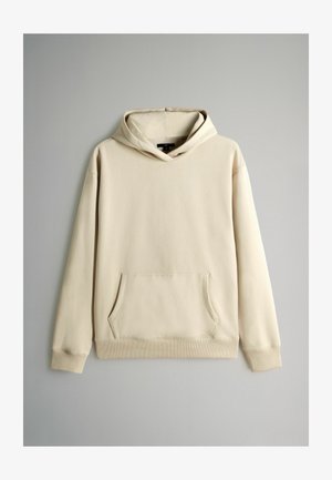 Lichtbeige katoenen hoodie met een voorzak in kangoeroestijl, lange mouwen en een capuchon met trekkoord. Soepele textuur en geribbelde details aan de onderkant.