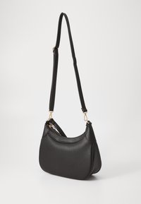 Black leather shoulder bag with a textured surface, curved shape, gold-tone hardware, and an adjustable strap for versatility.