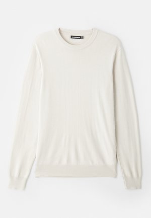 Maglione beige chiaro a maniche lunghe realizzato in tessuto morbido e liscio. Presenta un colletto rotondo a coste e orli con risvolto per una vestibilità classica.