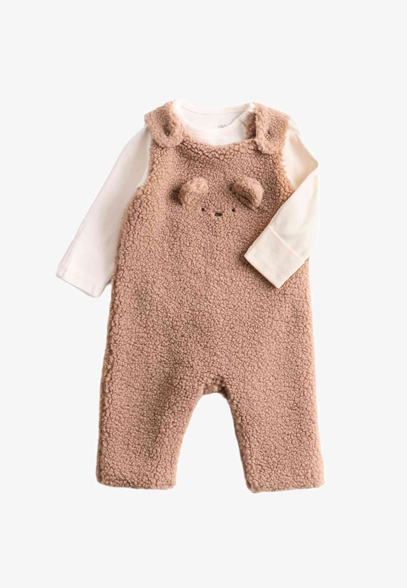 Fleece overall in beige with a textured finish, featuring a bear face design, rounded ears, and attached long-sleeve white shirt underneath.