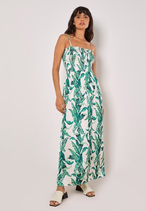 Maxikleid mit grünem Blattmuster auf weißem Hintergrund; taillierter Oberteil mit smockierter Textur; verstellbare Spaghettiträger; fließender Rock.