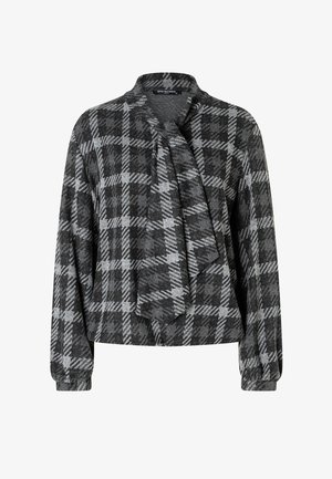 Black and grey plaid blouse with a shawl collar, long sleeves, and a draped front detail. Made from a textured fabric. Comfortable fit.