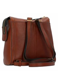 Sac en cuir marron porté travers avec une forme structurée, accents en métal doré, fermeture éclair et une sangle ajustable. Surface texturée avec des détails de couture.