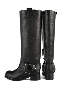 Black leather knee-high boots with a textured finish and a strap detail at the ankle, featuring metallic accents and a block heel.
