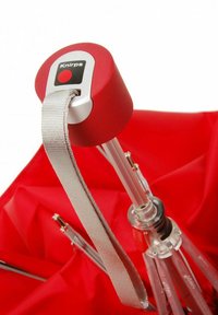 Red compact umbrella handle with a black button and gray strap; metal base with clear ribs. Fabric canopy in smooth texture, folded position.