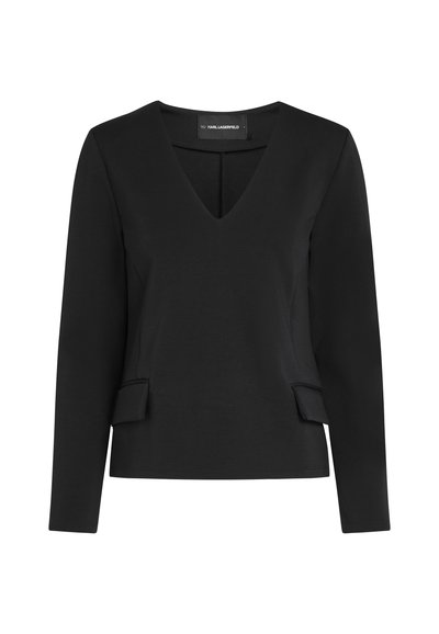 Haut noir à manches longues en V avec une silhouette ajustée et deux petits détails à rabat au niveau de la taille, étiqueté Karl Lagerfeld.