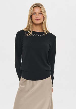 Black knit sweater with long sleeves and a ribbed hem, featuring decorative beading around the neckline. Smooth texture and fitted design.