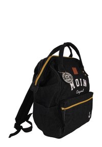 Black denim backpack with yellow zippers, front logo, and anchor detail. Features two main compartments and adjustable straps.