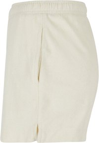 Ljusbeige shorts av mjukt tyg med elastisk midja, sidoventilation och enkel, odekorerad design.