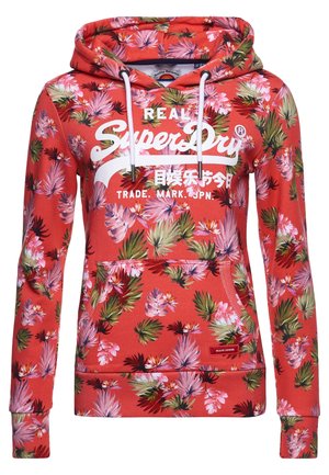 Sweat à capuche rouge avec imprimé floral tropical rose et vert, cordons blancs, poche avant et logo blanc "SuperDry" avec texte japonais.