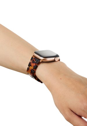Smartwatch with black screen and gold case on wrist, featuring a brown tortoiseshell patterned watchband.