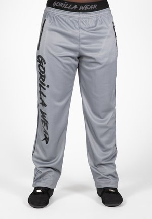 Gray mesh athletic pants featuring a black elastic waistband, side pockets, and bold black lettering along the left leg.