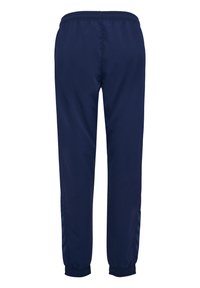 Marina träningsbyxor med elastisk midja, avsmalnande ben och chevrondetalj i en ljusare blå längs sidsömmarna.