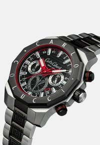 Men's watch with octagonal black stainless steel case, black dial, red accents, chronograph features, and silver link bracelet with black pattern.