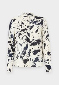 Πουκάμισο με μακριά μανίκια σε κρεμ χρώμα με μεγάλο μαύρο σχέδιο πιτσιλιών. Διαθέτει μυτερό γιακά και εμπρός με κουμπιά. Ομαλή υφή υφάσματος.