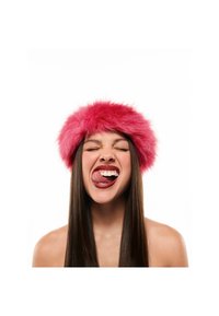 Pink faux fur hat with a wide, fluffy band. Smooth, straight dark hair and visible teeth. Bright background, minimal distractions.