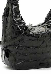 Borsa in pelle verniciata nera con motivo a quilt, dotata di dettagli circolari e una sola tracolla. Chiusura con zip sulla parte superiore.