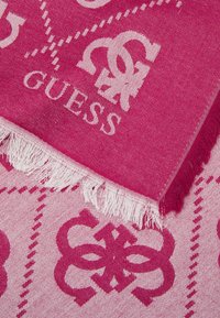 Lyserød mønstret tørklæde med et fremtrædende logo og frynse-detaljer. Designet inkluderer geometriske former og subtile teksturvariationer.