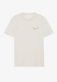 Cream-colored short-sleeve T-shirt made of soft fabric, featuring a small brown whale embroidery on the left chest. Round neckline, relaxed fit.