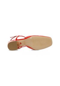 Red patent leather high heel with a square toe and ankle strap. Smooth texture, beige rubber sole, with a round logo detail on the bottom.