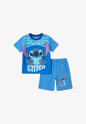 Tenue bleue pour enfants avec le personnage Stitch sur le t-shirt et le short ; le t-shirt présente un motif ondulé et le texte "STITCH", le short montre Stitch tenant une poupée.