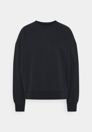 Sudadera negra de mezcla de algodón, con cuello redondo, mangas largas y puños acanalados. Logotipo sutil en el pecho.