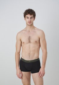 Schwarze Baumwoll-Boxershorts mit einem kontrastierenden grünen Taillenbund mit dem Logo "JACK & JONES", schlichtem Design und enganliegendem Schnitt.