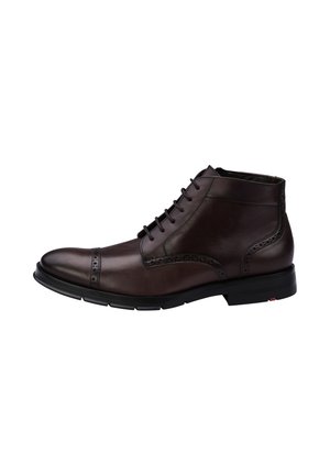 Dark brown leather ankle boot with lace-up front, brogue detailing, and black sole, shown from the side on a white background.