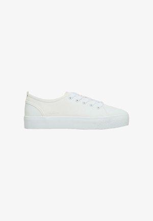 Low-top white canvas sneaker with white laces, thick rubber sole, and textured toe cap, shown from the side on a white background.