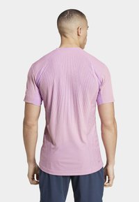 adidas Performance TENNIS PRO AIRCHILL FREELIFT - Potiskana majica - semi pink spark/preloved purple