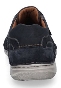 Navy suede casual shoe with a textured gray outsole, brown inner lining, and stitching details. Features a low-profile design.