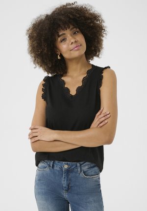 Black sleeveless top with scalloped lace trim at the neckline and armholes, made of a soft fabric. Paired with blue jeans.