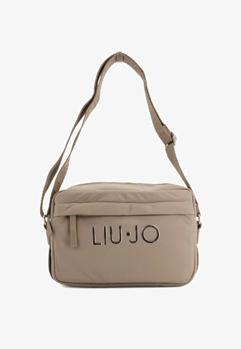 Beige nailonist rihmukott, millel on reguleeritav rihm, lukuga sulgemine ja logo detail esiküljel. Omab siledat tekstuuri ja ristkülikukujulist vormi.