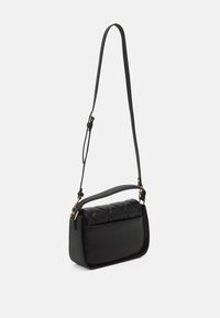 Schwarze Schultertasche mit strukturiertem Design, ausgestattet mit einer strukturierten Oberplatte und glattem Boden. Enthält einen langen verstellbaren Trageriemen und goldene Hardware.