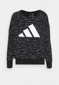 Sudadera negra con un patrón triangular blanco y un gran logo blanco en el centro. Cuello redondeado y puños acanalados.