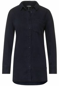 Námořnická modrá košile s dlouhým rukávem a límečkem, s jednou náprsní kapsou a mírně zakřiveným lemem. Vyrobena z měkké, hladké tkaniny.