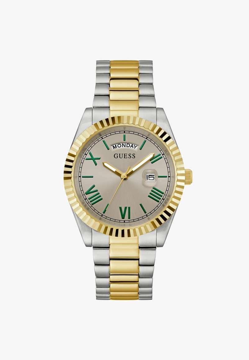Zegarek w kolorze srebrnym i złotym z teksturowanym bezel. Posiada srebrną tarczę, zielone rzymskie cyfry, wyświetlacz dnia/miesiąca oraz metalową bransoletę.