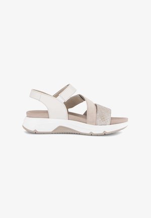 Beige en witte damessandaal met dempende zool, verstelbare enkelband en gestructureerde voorste band, geschikt voor casual gebruik.