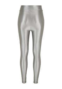Colanți argintii metalici cu talie înaltă, având o textură netedă și lucioasă și un design mulat, subțiere spre glezne.