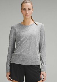 Grijs sportshirt met lange mouwen, gemaakt van een gestructureerde, ademende stof. Heeft een ronde hals en een slim-fit ontwerp.