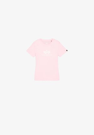 T-shirt rosa a maniche corte in cotone. Presenta un logo bianco "ALPHA INDUSTRIES" con grafiche stilizzate sul davanti. Collo rotondo.