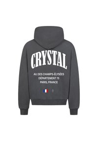 Felpa grigia con testo bianco: "CRYSTAL," "AV. DES CHAMPS-ÉLYSÉES," "DÉPARTEMENT 75," "PARIGI, FRANCIA," e una piccola bandiera francese.