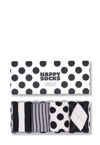 Coffret noir et blanc comprenant quatre paires de chaussettes mi-mollet avec divers motifs : rayures, pois et argyle, le tout présenté dans une boîte à pois.