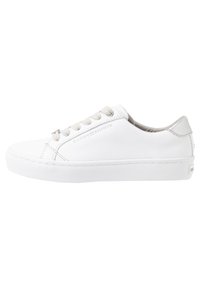 White low-top sneaker with beige laces, platform sole, and subtle Tommy Hilfiger branding on the side and heel.