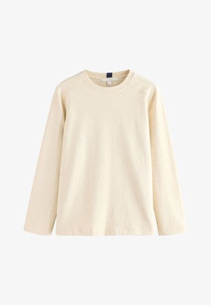 Tričko s dlouhými rukávy a kulatým výstřihem v světle béžové barvě, vyrobené z měkké bavlněné směsové látky. Má strukturovaný povrch a raglánové rukávy.