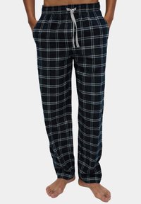 Zwart-wit geruite katoenen pyjamabroek met elastische tailleband, trekkoord en zijzakken, met een losse pasvorm en zachte textuur.