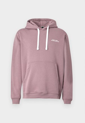 Heledalt roosa kapuutsiga särk, millel on valged nöörid, esikott ja soonikuga varrukad. Vasakul rinnal on valge brändi tekst.