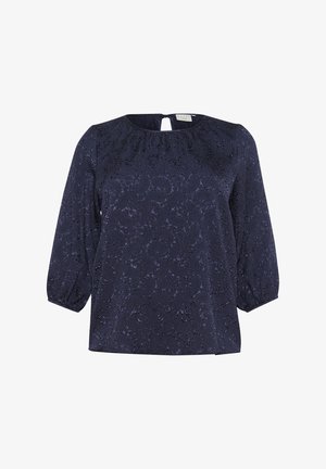 Blouse bleu marine avec un motif floral texturé, col rond, détail dos en clé et manches bouffantes trois quarts.