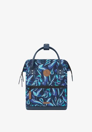 Navy blue backpack with a leaf pattern in green and turquoise; features a top handle, front zip pocket, and leather accents.